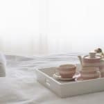 low cost ways to spruce up your home-make the bed photo of bed with tray with tea pot and cups